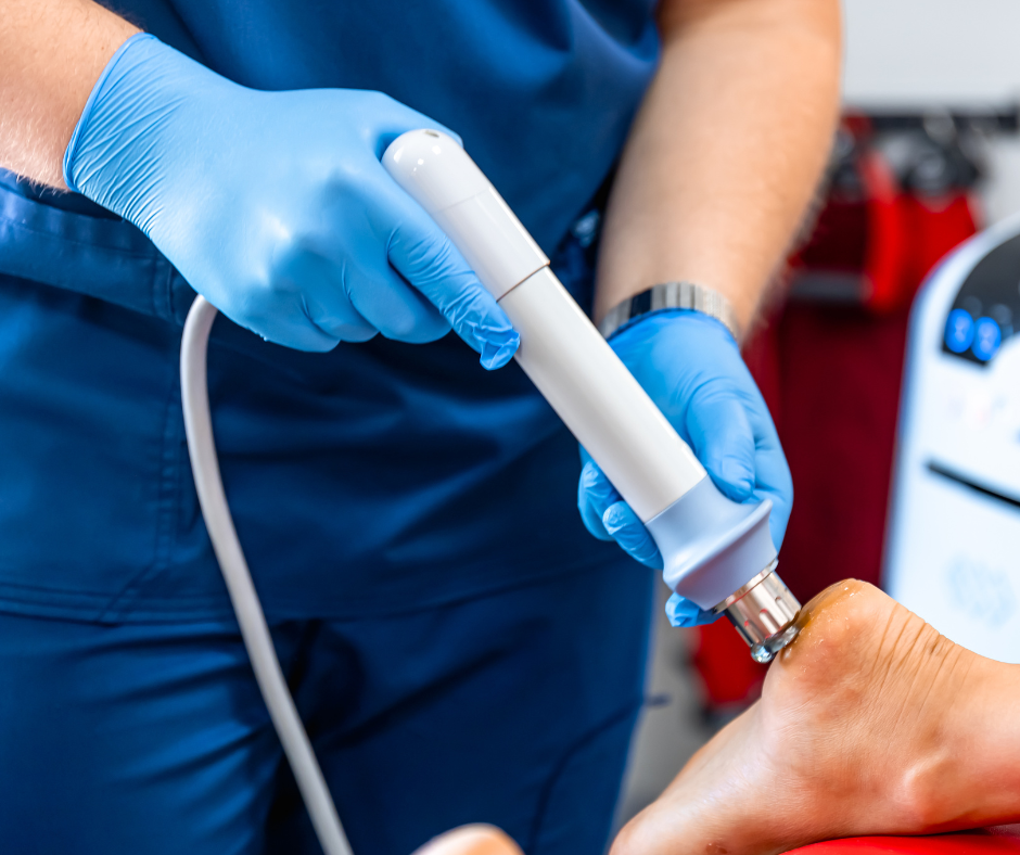 medical professional performing shockwave therapy on foot